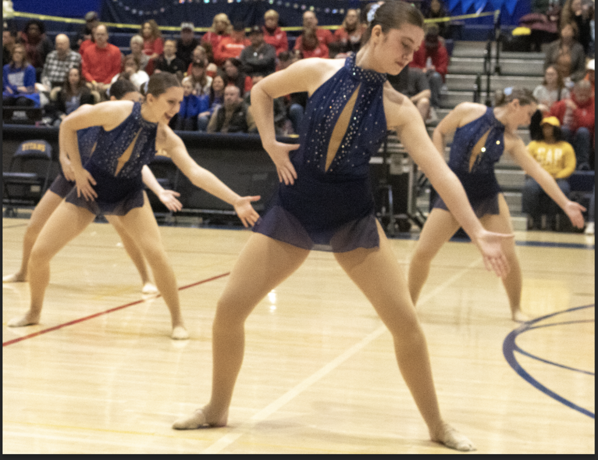 JV Poms stunned both judges and onlookers with a Jazz routine for the 50 team championship on Jan. 26. Their excellent routine, seen performed here by sophomores Keira Stender, Lucy Anderson, and Sara Rosenthal (left to right), allowed them to take home fourth place. 